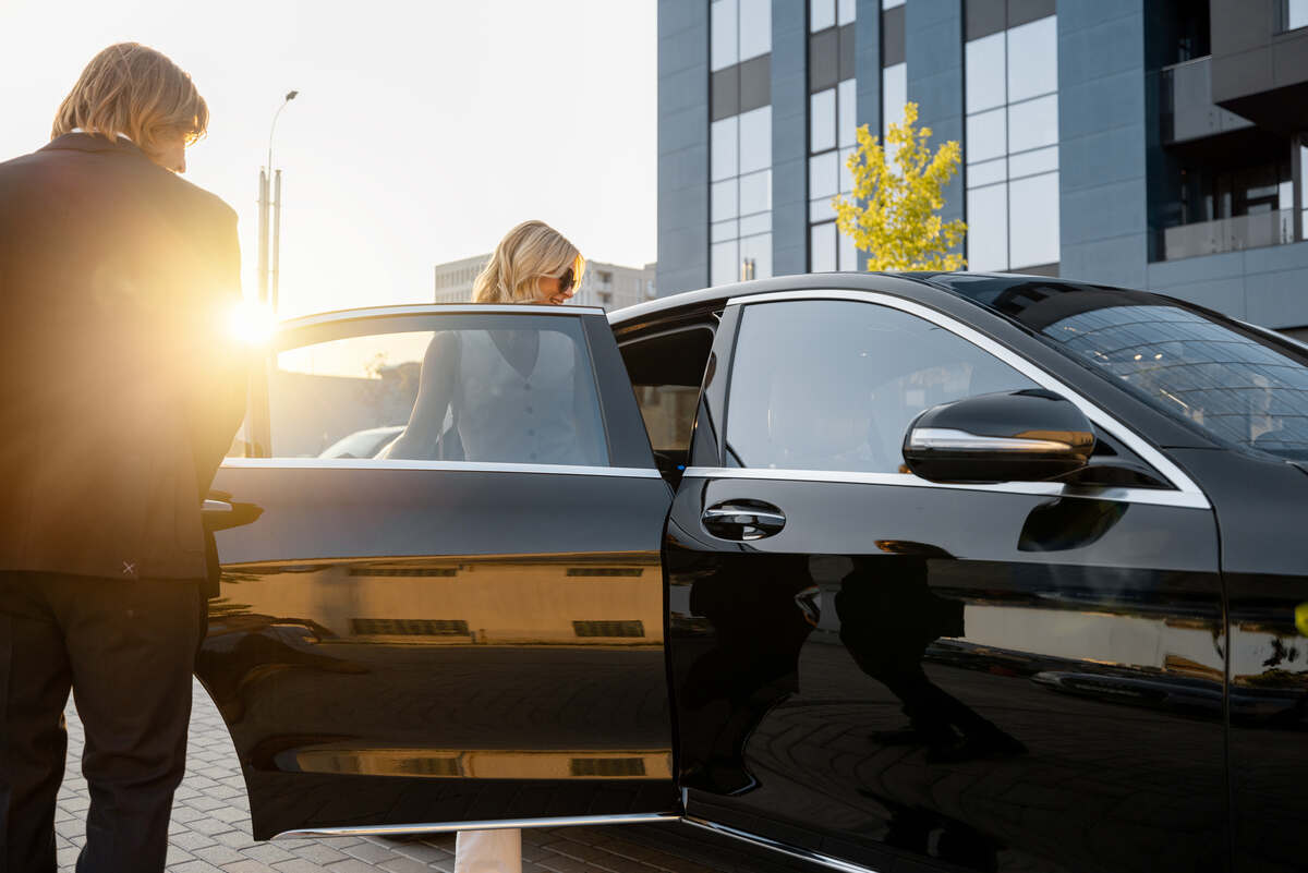 Business couple get in the car