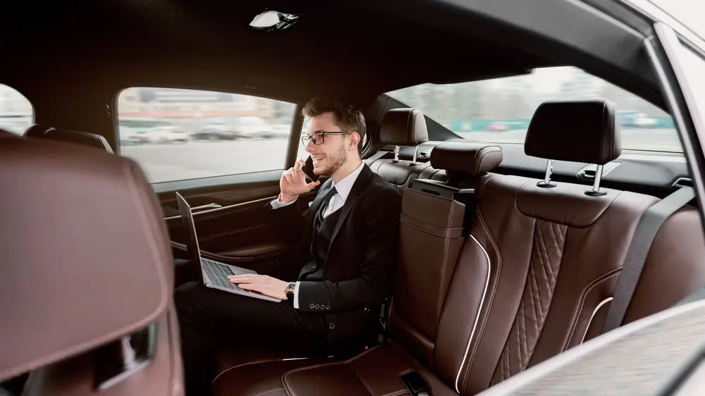 young businessman talking on the phone in limousine